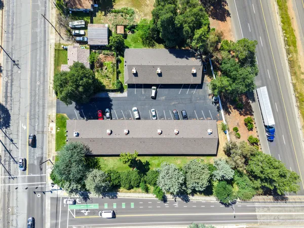an aerial view of a house with a yard and garden