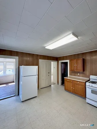 a kitchen with microwave a stove and cabinets