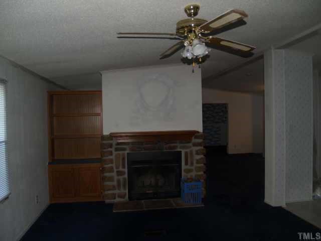3633 Macedonia Road Spring Hope, NC 27882 - Photo 2 of 6 a kitchen with stainless steel appliances a fireplace and cabinets