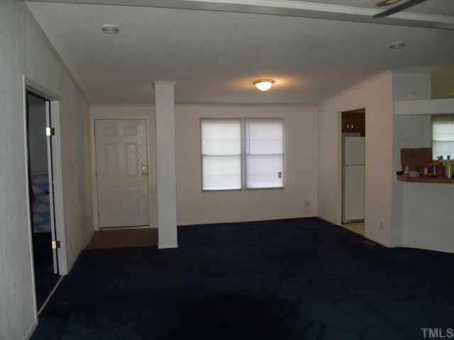 3633 Macedonia Road Spring Hope, NC 27882 - Photo 3 of 6 a view of an empty room with wooden floor and a window