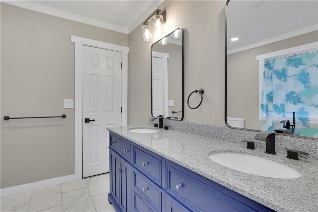 4913 Windsor Downs Drive Decatur, GA 30035 - Photo 19 of 26 a bathroom with double vanity sinks and a mirror