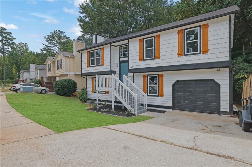 4913 Windsor Downs Drive Decatur, GA 30035 - Photo 2 of 26 a front view of a house with a yard and trees