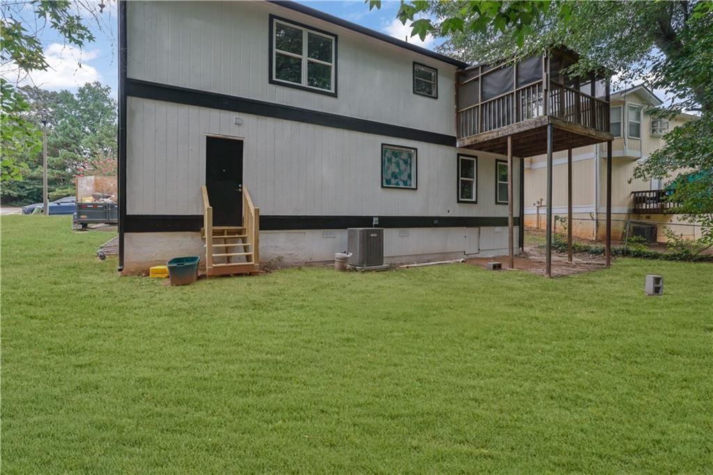 4913 Windsor Downs Drive Decatur, GA 30035 - Photo 26 of 26 a view of an house with backyard space and a tree