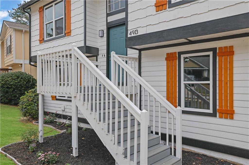 4913 Windsor Downs Drive Decatur, GA 30035 - Photo 3 of 26 a view of staircase with railing and a rug