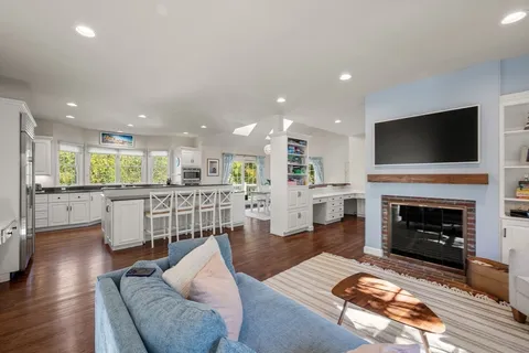 a living room with furniture a fireplace and a flat screen tv