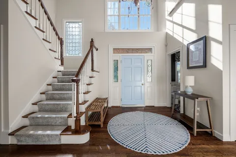 a view of entryway and hall with wooden floor