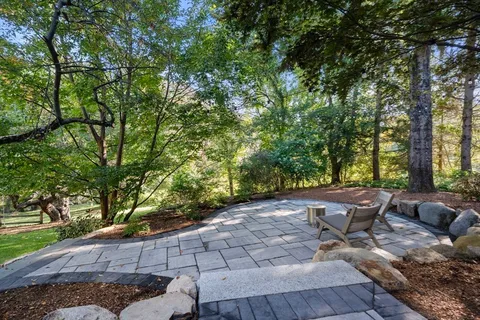 a view of a backyard with sitting area