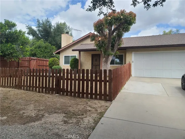 a front view of a house with tree s