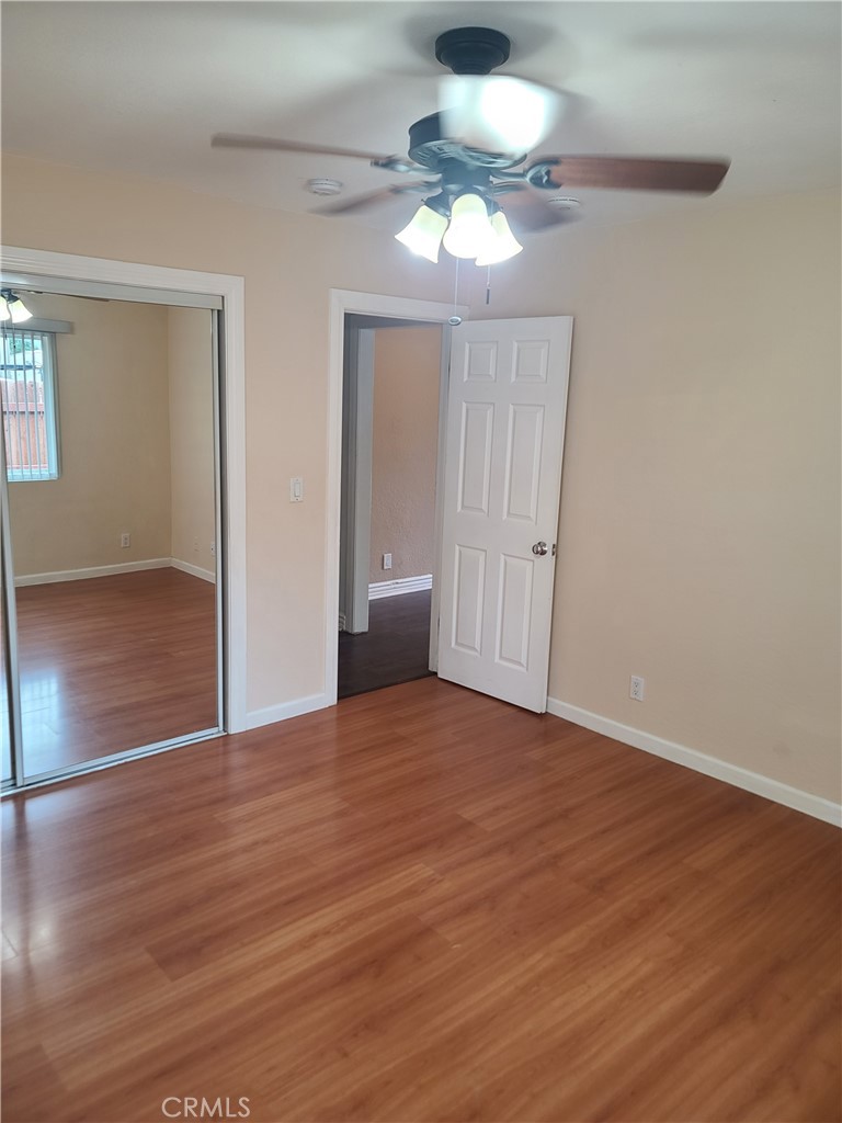 Undisclosed Address Simi Valley, CA 93063 - Photo 15 of 17 a view of an empty room with wooden floor and a ceiling fan
