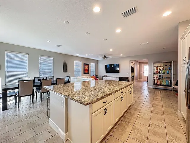 a large kitchen with cabinets stainless steel appliances and a center island