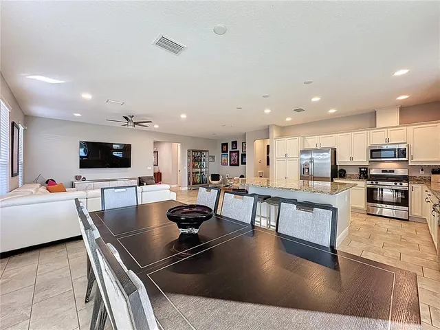 a view of a dining room with a table and chairs