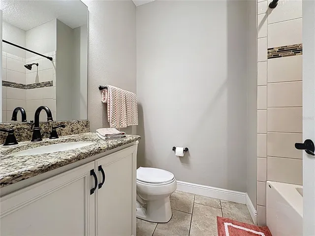 a bedroom with a bed and a ceiling fan