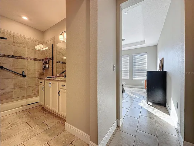 a bedroom with furniture and a ceiling fan