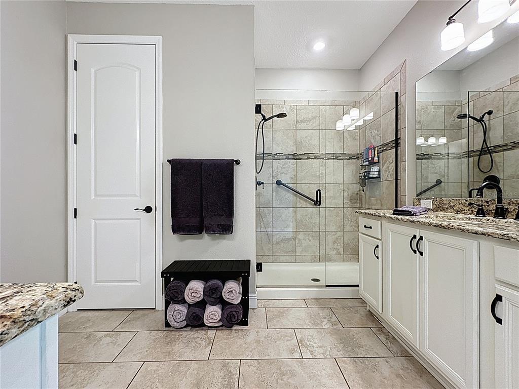 115 Silver Maple Road Groveland, FL 34736 - Photo 27 of 79 a bathroom with a granite countertop sink a toilet and shower