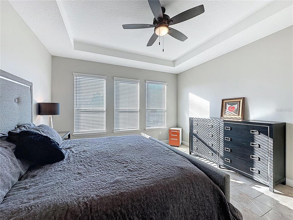 115 Silver Maple Road Groveland, FL 34736 - Photo 31 of 79 a bedroom with a bed dresser and a window