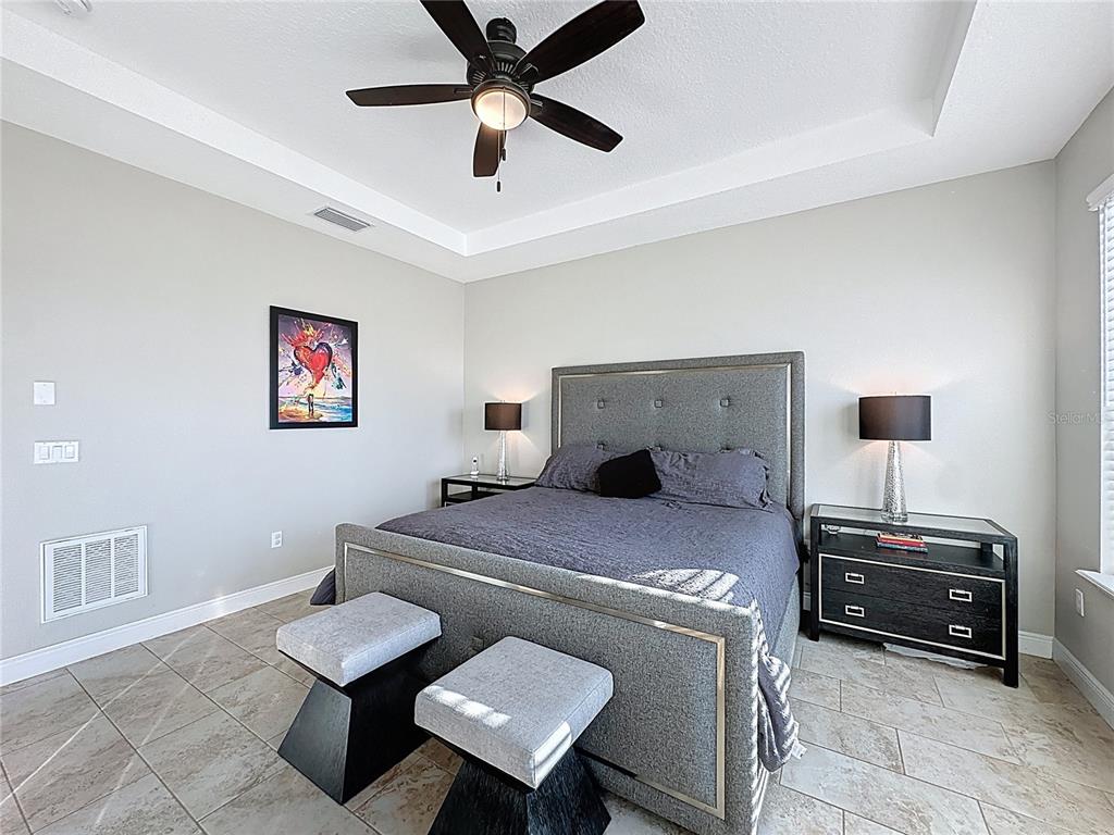 115 Silver Maple Road Groveland, FL 34736 - Photo 33 of 79 a bedroom with furniture and a ceiling fan