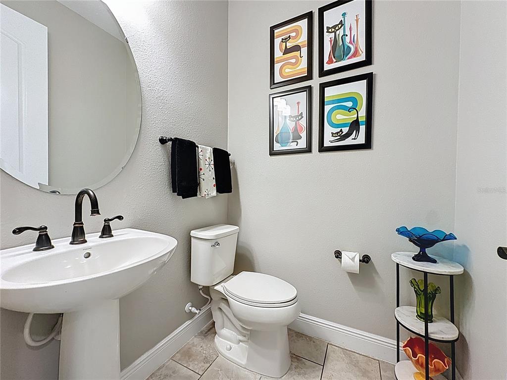 115 Silver Maple Road Groveland, FL 34736 - Photo 37 of 79 a bathroom with a toilet sink and mirror