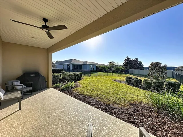 a living room with lots of furniture and a large window