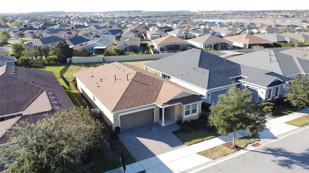 115 Silver Maple Road Groveland, FL 34736 - Photo 48 of 79 an aerial view of a house with a yard garage and lake view