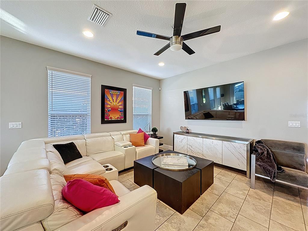 115 Silver Maple Road Groveland, FL 34736 - Photo 7 of 79 a living room with furniture and a flat screen tv