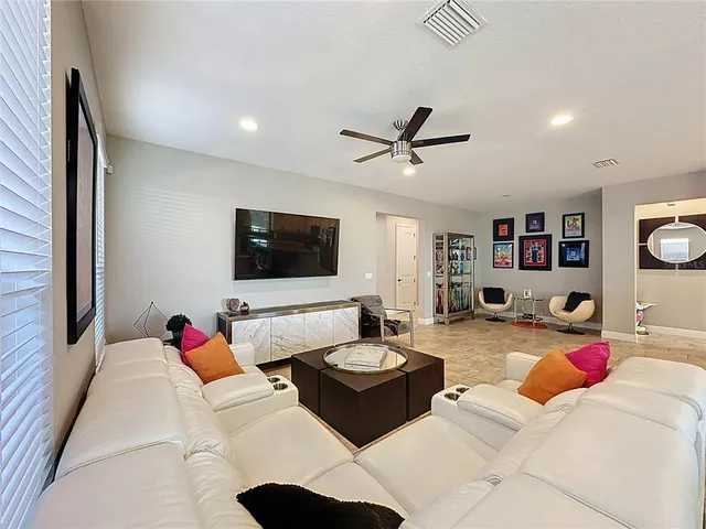 a living room with furniture and a floor to ceiling window
