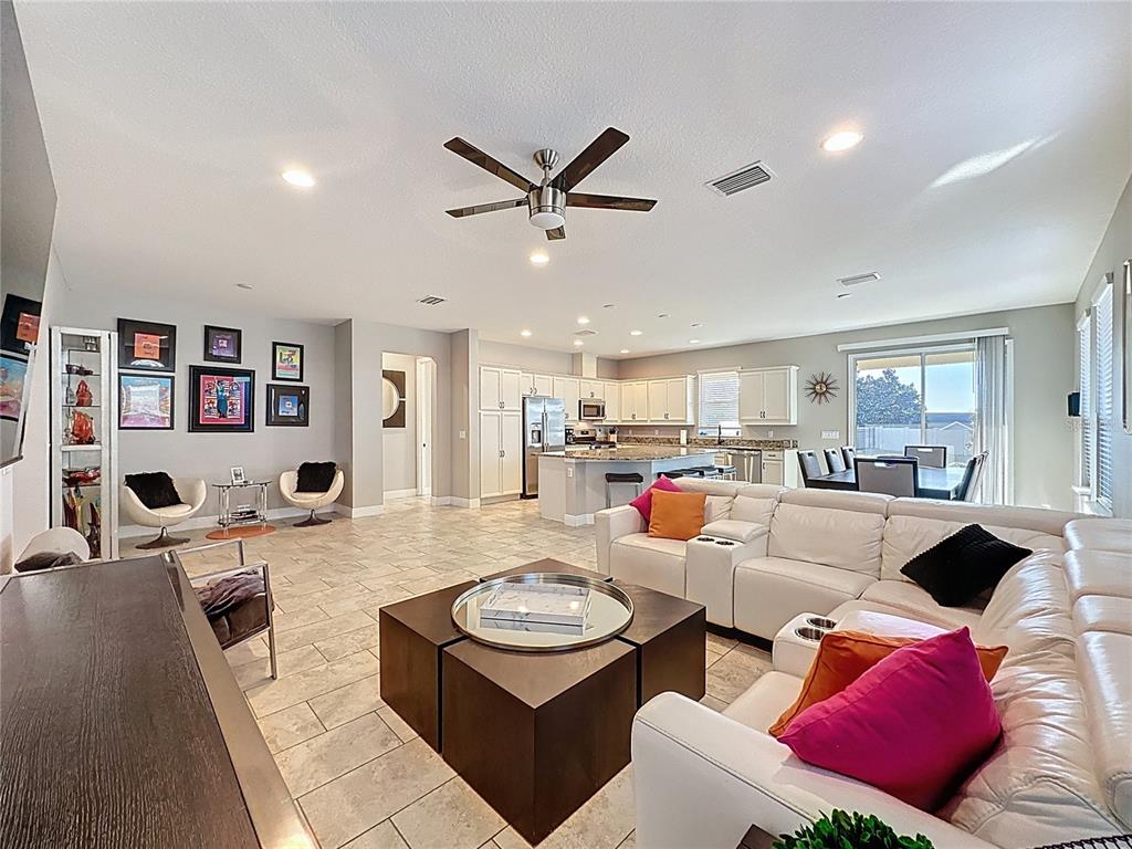 115 Silver Maple Road Groveland, FL 34736 - Photo 10 of 79 a living room with furniture kitchen view and a large window