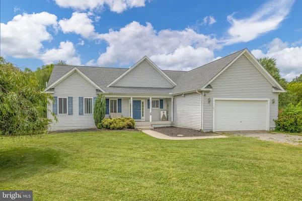 a front view of house with yard and green space