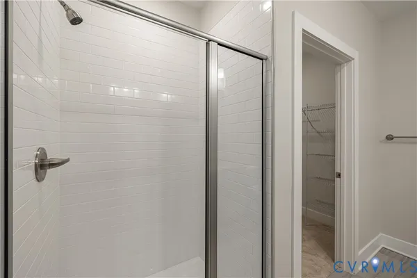 a bathroom with a glass shower door