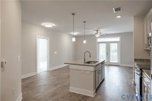 a kitchen with a sink stove and cabinets