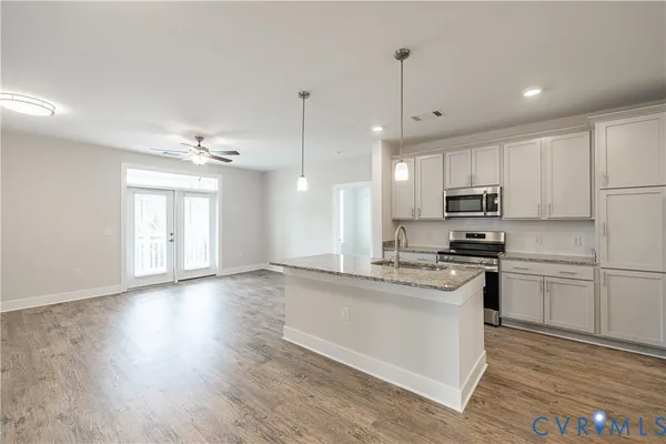 a kitchen with stainless steel appliances granite countertop a stove and a refrigerator