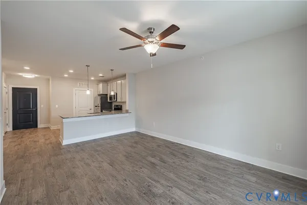 a view of an empty room with wooden floor