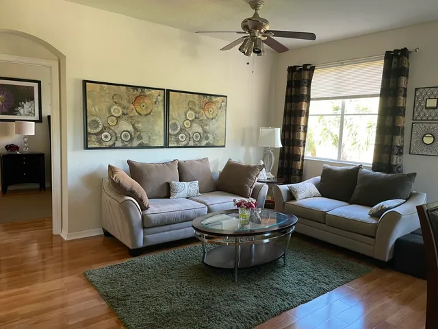 a dining room with furniture and wooden floor
