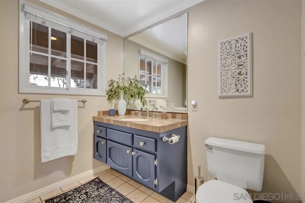 133 Hummingbird Hill Encinitas, CA 92024 - Photo 13 of 25 a bathroom with a granite countertop toilet sink and mirror