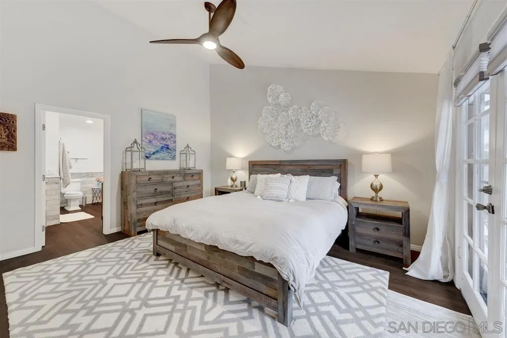 133 Hummingbird Hill Encinitas, CA 92024 - Photo 19 of 25 a bedroom with a bed and a chandelier