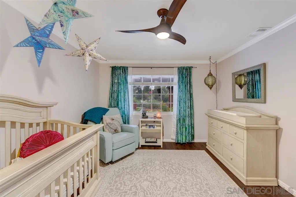 133 Hummingbird Hill Encinitas, CA 92024 - Photo 8 of 25 a spacious bedroom with a bed and a chandelier