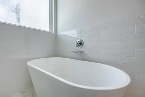 a white bath tub sitting in a bathroom
