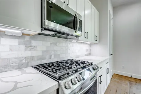 a kitchen with a stove and a microwave