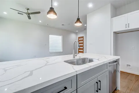 a kitchen with a sink and chandelier