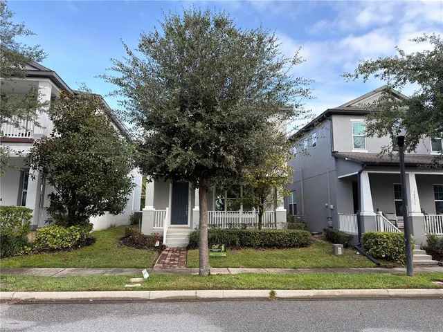 a front view of a house with a yard garage and outdoor seating