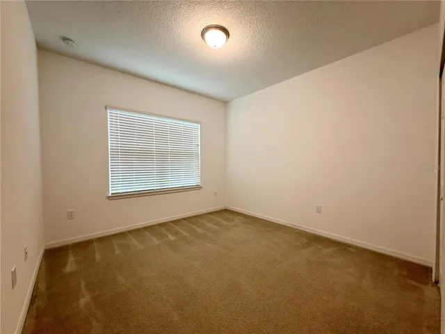 an empty room with a empty space and windows