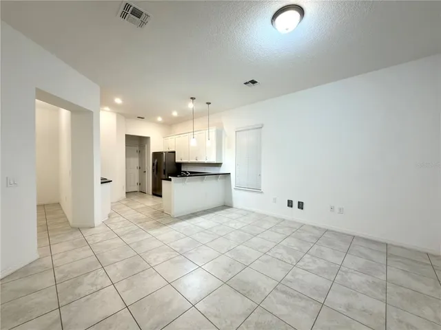 a view of kitchen refrigerator and window