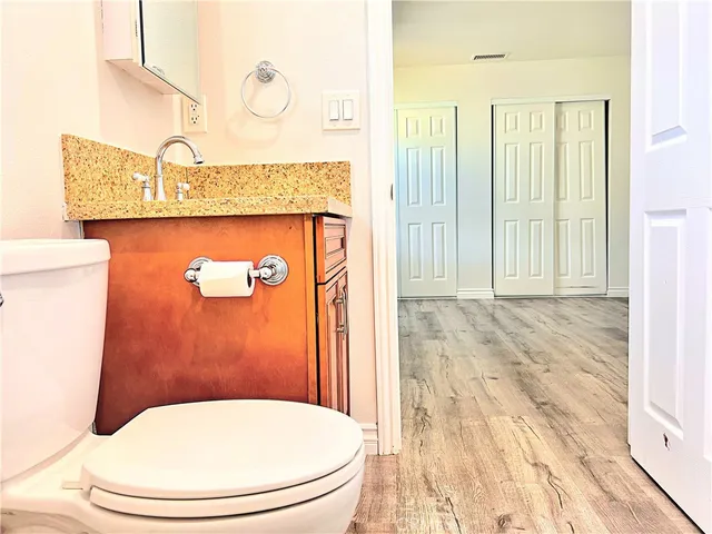 a view of a bathroom with wooden floor