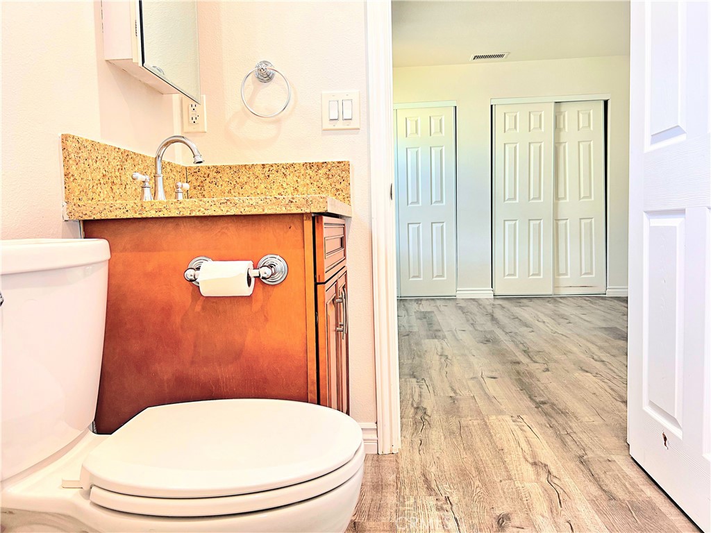 20009 Arminta Street Winnetka, CA 91306 - Photo 14 of 29 a bathroom with a toilet a sink and mirror