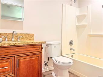 20009 Arminta Street Winnetka, CA 91306 - Photo 20 of 29 a bathroom with a toilet a sink and a bathtub