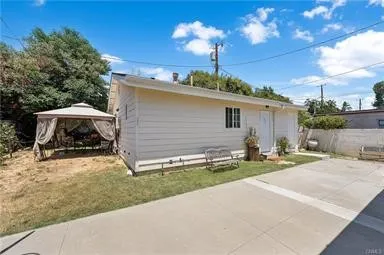 a view of a house with backyard and sitting area