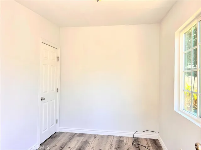 a view of a patio with dining table and chairs with wooden floor and fence
