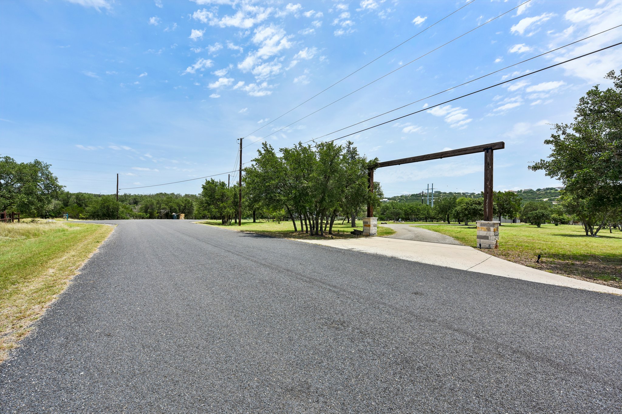 2203 Improver Road Spicewood, TX 78669 - Photo 24 of 38 A private entry welcomes you to a serene expanse, perfect for a rural escape.