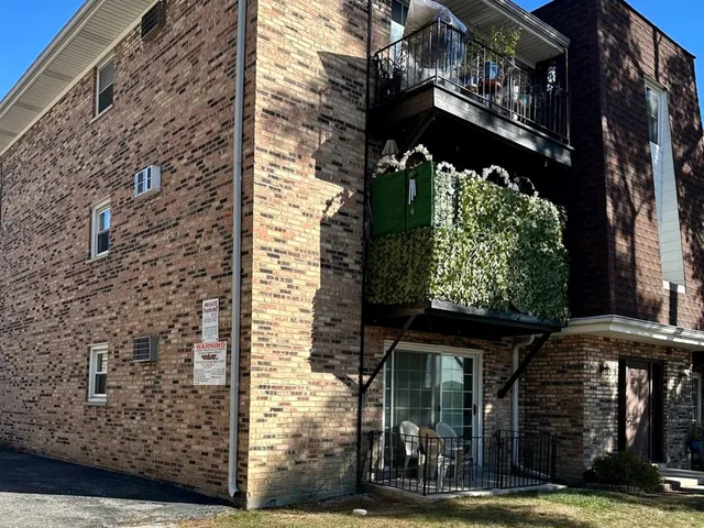 a front view of a building with garden