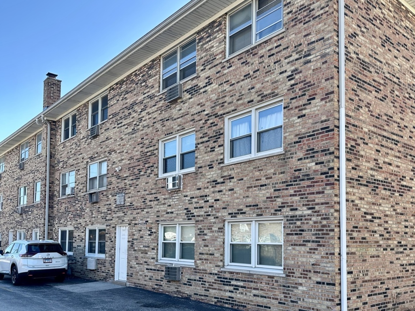 7008 O'Connell Drive, Unit 201 Chicago Ridge, IL 60415 - Photo 18 of 21 a brick building with a door and a yard