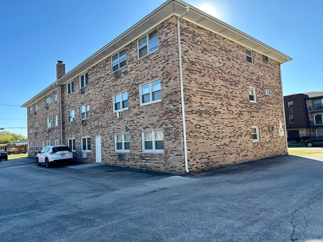a view of building with car parked